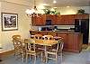 Dining table seats 6 comfortably with room for 3 additional people at the bar