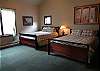 2 queen beds, TV, good closet space and shared full bath.