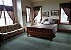 Bedroom with queen bed, TV  and shared full bath