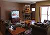 The living room features a large TV with Blu Ray player, XBOX 360 with Kinect, and a gas fireplace.