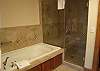 The beautiful master bathroom features a jetted tub and separate, oversized shower.