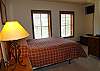Second bedroom with flat screen TV and plenty of windows
