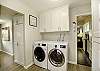 Laundry day just got an upgrade! Discover a full-size washer and dryer in our conveniently located laundry center, right off the kitchen. 