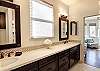 Master suite has a large walk-in shower, double vanity sinks.