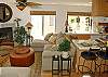 Open kitchen area off living room, includes kitchen island with 4 barstools for extra seating.