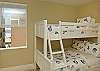 Double trundle bunk bed bedroom with ocean view.