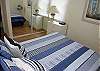 this master bedroom has a queen bed.