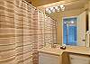 Full bathroom with towels, hair dryer and starter supply of shampoo and soap!