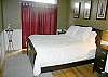 The bedroom features a queen size bed.