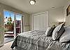 Queen size bed and sliding glass door to the Flagstone patio.