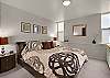 King size bed, flat screen television and pass through bathroom
