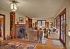 Living room features a wood burning fireplace and a full wall of french doors leading out to a large entertaining size deck overlooking Interlakken Park!