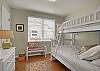 The adorable second bedroom features a twin over full bunk bed sleeping 3.
