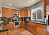 Full kitchen with granite tile countertops, stainless steel appliances and beautiful hardwoods.