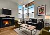 High ceilings, luxury sofa sleeper, flat screen television and gas fireplace