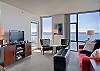 Spacious Living Room features floor to ceiling corner windows overlooking Elliot Bay!  Patio is accessed off the living room.  The Patio also looks out over Elliot Bay