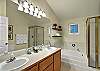 Top floor bathroom offers "His and Her" sinks, large bathtub and separate shower.