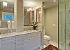 Double sinks, marble and glass shower.