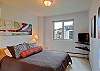 Queen size bed and flat screen television with cable.