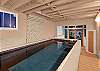 This home uniquely features a small indoor heated resistance swimming pool!