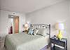 The master bedroom features a king size bed, views of the water, an ensuite bathroom, and cable tv.