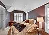 King size bed and flat panel television with pass through bathroom.