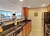 Stainless steel appliances and granite countertops with tile floor.