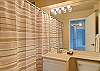 Full bathroom with towels, hair dryer and starter supply of shampoo and soap!