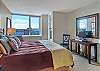 Large bedroom, King size bed, television, ensuite bathroom and balcony access.