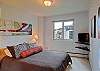 Queen size bed and flat screen television with cable.