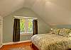 Spacious bedroom with queen size bed and charming built-in closets.