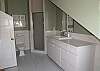 Wood flooring, full bath with shower and alcove offering warm, natural light