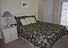 Second bedroom on main level features queen bed and private bath