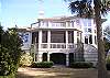 Rear of the home with screened porch, open deck to the right and upper deck
