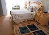 Large master suite with king bed, sitting area with love seat, TV and full private bath with tub/shower and double vanity
