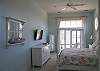 Lots of light and flat screen wall mounted TV.