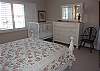 Downstairs queen bedroom with crib and private bath.
