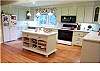 Updated kitchen with Corian counters and hardwood floors