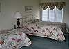Upstairs bedroom suite with queen and twin beds, private bath and deck overlooking the golf course