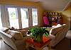 Upstairs loft/den sitting area leads to the covered porch with ocean views