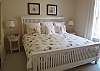 King bedroom with flat screen TV and full bath with tile shower