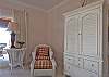 The master suite is quite large and features a screened porch.  TV in armoire