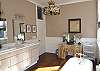 Charming bath with claw foot tub, pine flooring, separate shower, make up table and double vanity.