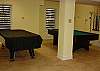 Another view of the game room with pool table and air hockey