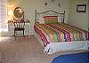 Second bedroom features a queen bed and twin bed with trundle