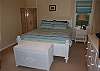 Bedroom with queen bed shares bath with king bedroom