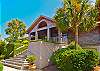 Custom designed with cedar shingles.  There are two garage car bays