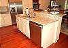 Granite counter tops and convenient bar overlooking dining and living area