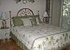 Queen bed and wood flooring, bedroom is to the right