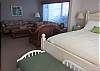 Large bedroom with queen bed and sitting area